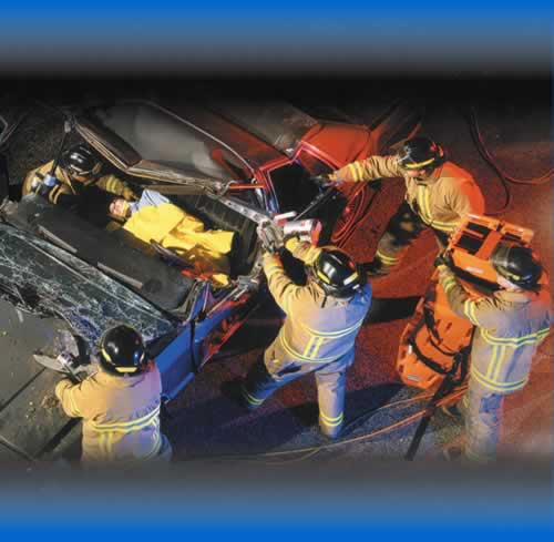 Accident Scene showing firemen attending to a car crash